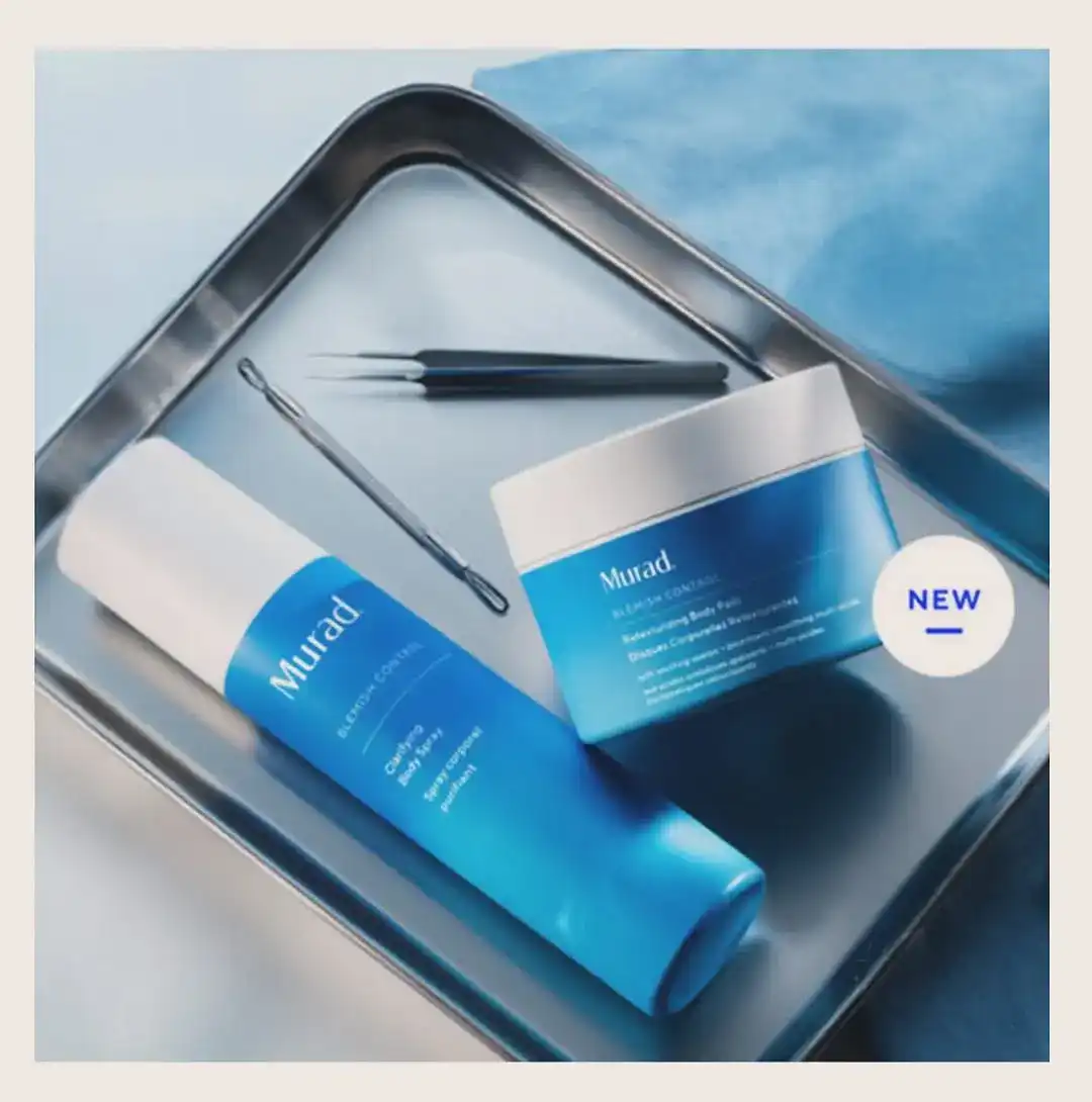 Murad Blemish Control clarifying body spray and body pads on a stainless steel tray