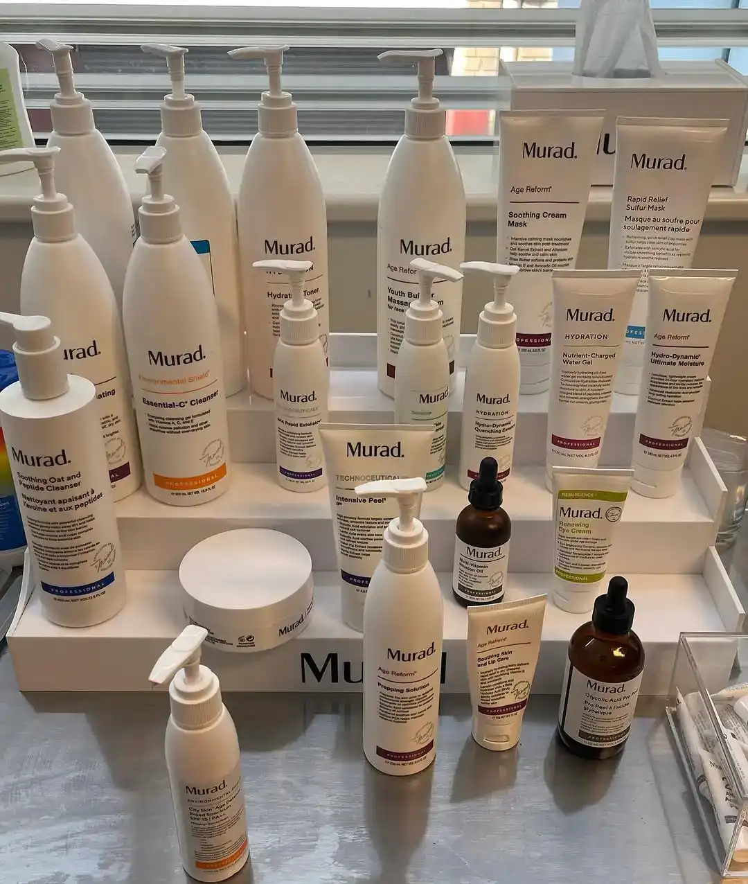 A tiered shelf of Murad professional skincare in the clinic, including cleansers, toners, masks, serums and moisturisers