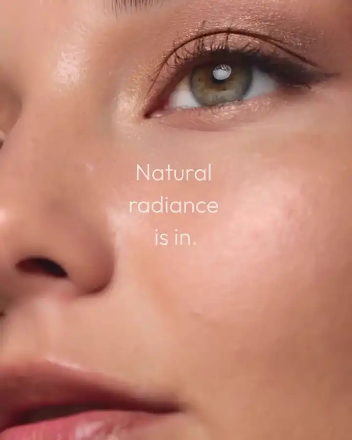 Close-up of a face, captioned 'Natural radiance is in.'