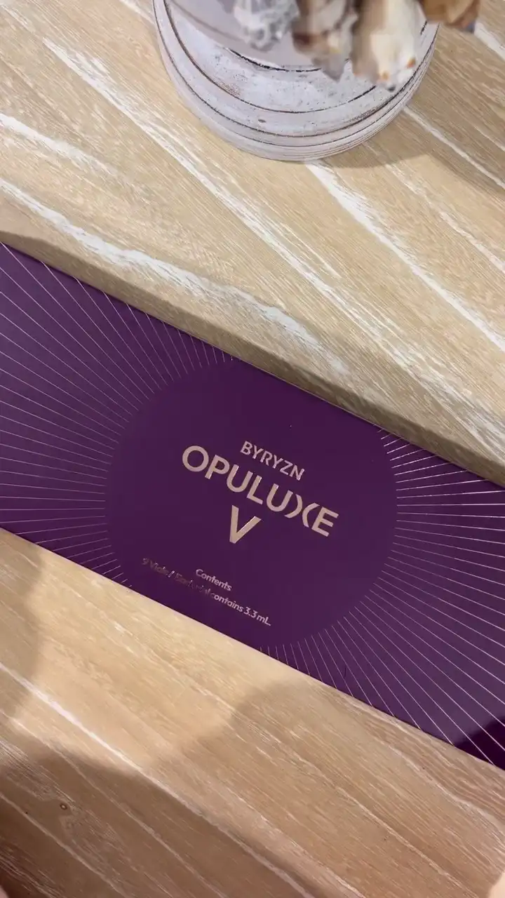 A BYRYZN Opuluxe V box of nine vials on a timber bench